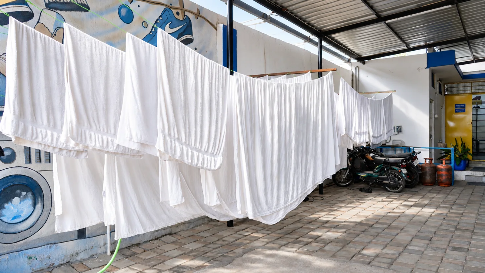 Laundry On Us white linen drying area shown with a before-cleaning visual treatment